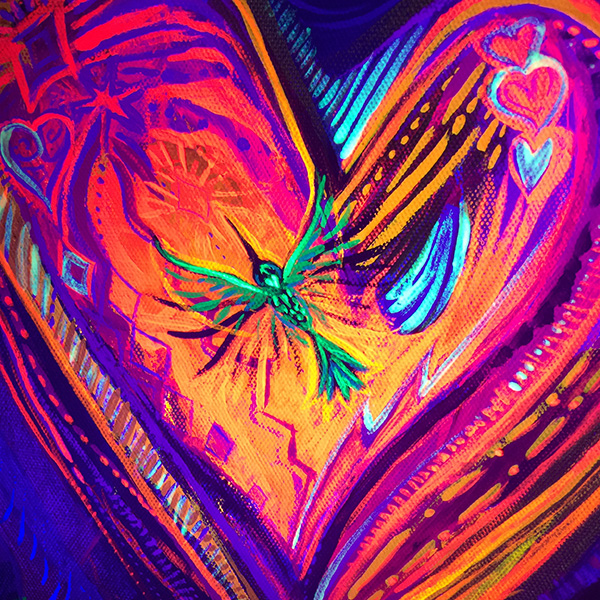 Close up of center heart and humming bird under the black light